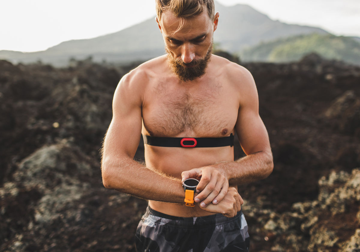 An athlete checking a heart-rate monitor before a session